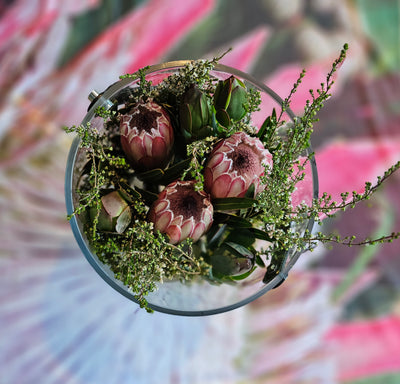 Protea Flowers in a display vase on a protea table cloth