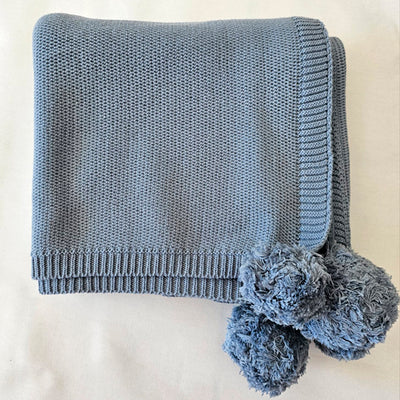 blue blanket with pompoms