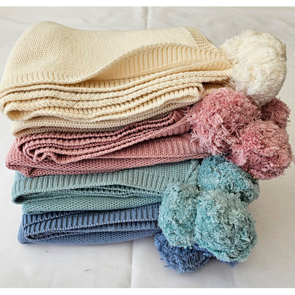 stack of yellow, pink, blue and mint blankets